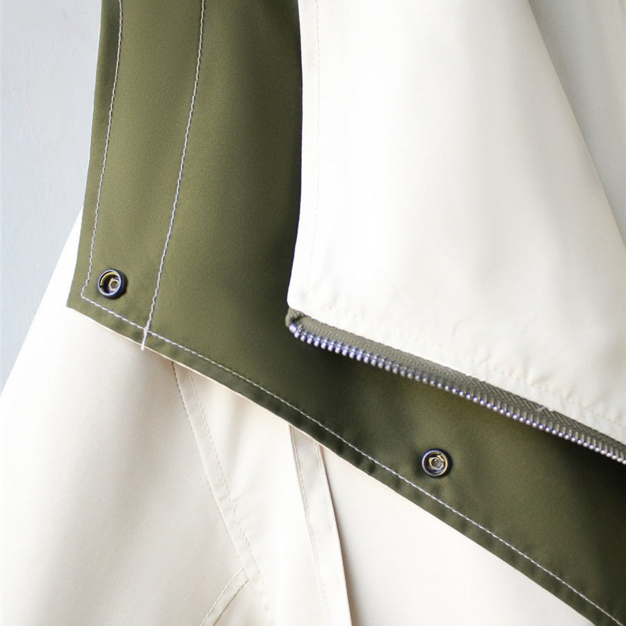 Windbreaker hem trim detail: olive and off-white panels with snap buttons