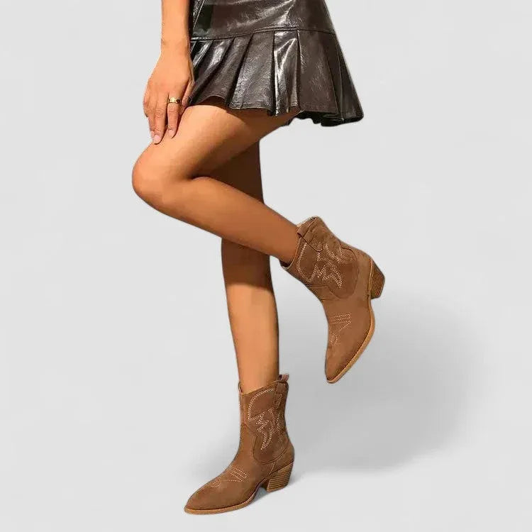 Brown suede western boots with pointed toe, mid-heel, and embroidered side detailing