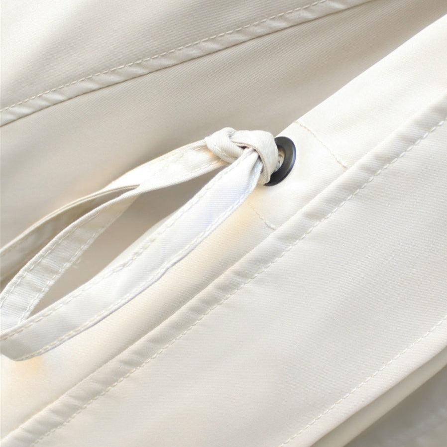Off-white windbreaker drawcord detail with black grommet and stitched channel