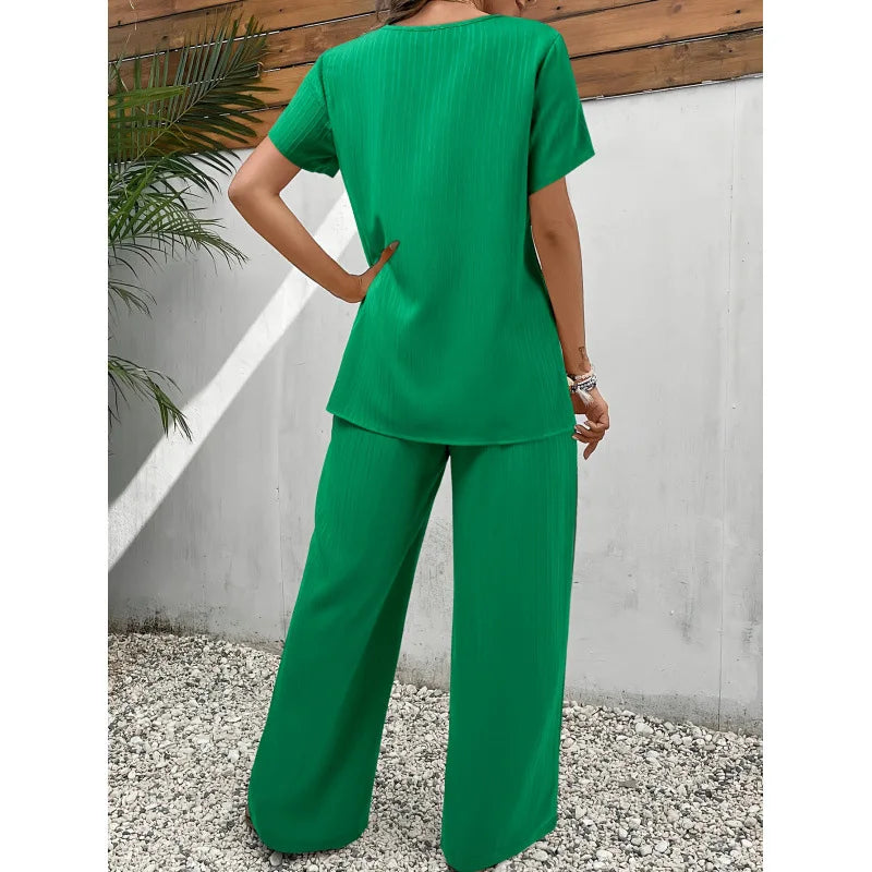 Green draped two-piece set, back view: short-sleeve top and wide-leg pants