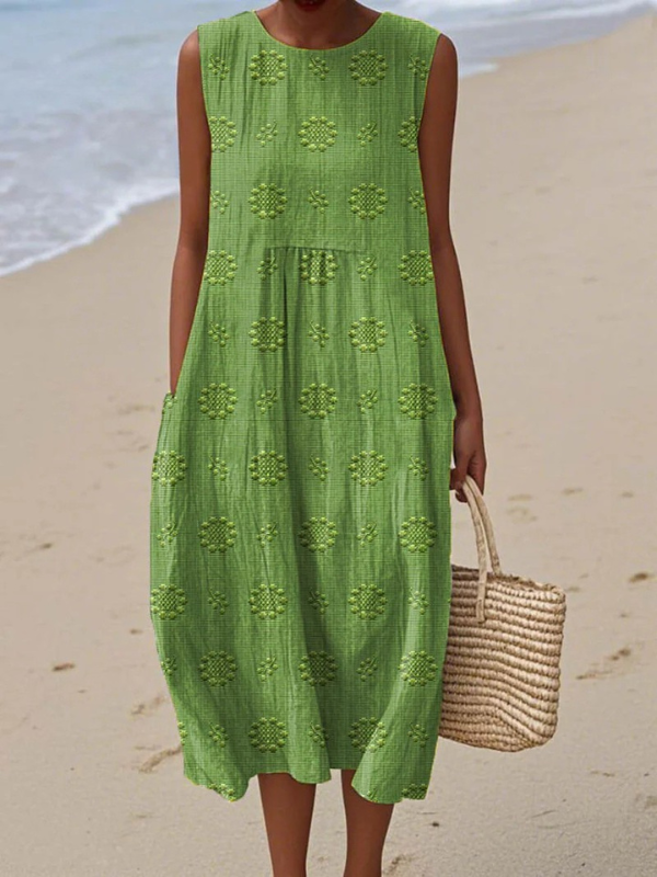 Green patterned sleeveless midi dress with round neck and tiered skirt detail