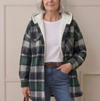 Plaid hooded flannel shacket on model, green-and-gray plaid with cream hood lining