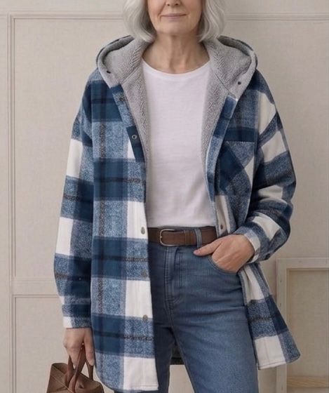 Plaid hooded flannel shacket on model, blue-and-white plaid with gray hood lining