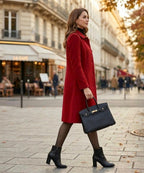 Red long coat with notched lapels and button front, side view with sleeves to wrist