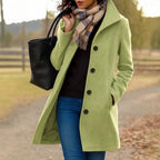 Light green long button-front coat with notched lapels and flap pockets, lined.