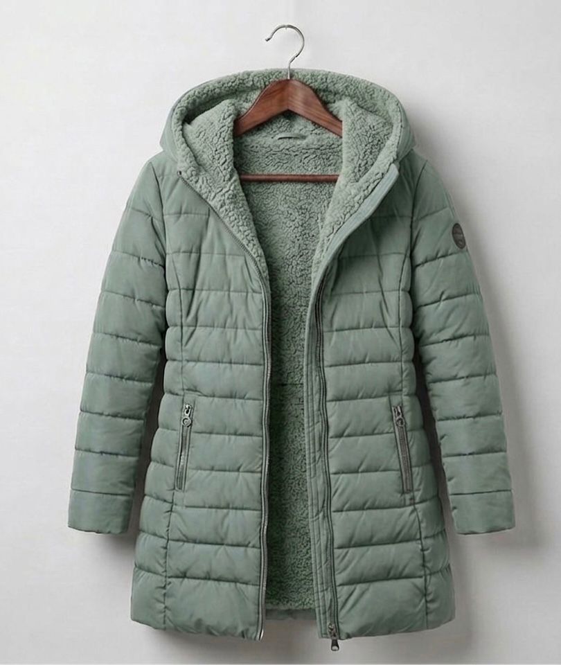Olivia™ quilted A-line winter coat in light green with hood and zip front.