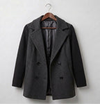 Ribbed blazer coat in dark gray, hanging on a wooden hanger with double-breasted buttons
