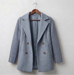 Ribbed blazer coat in light gray-blue, hanging on a wooden hanger with double-breasted buttons