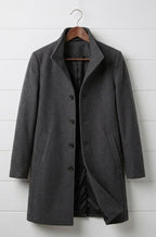 Grey long coat with notch lapels, dark buttons, and front patch pockets.