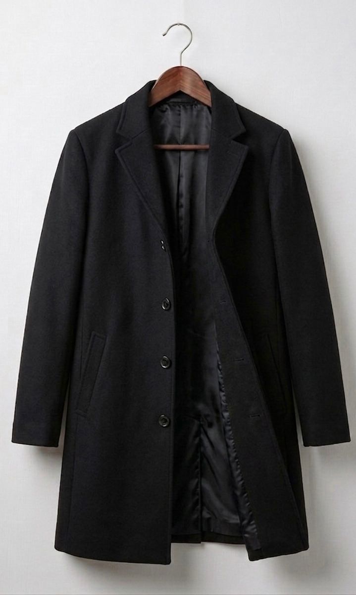 Black long coat with notch lapels, dark buttons, and quilted inner lining.