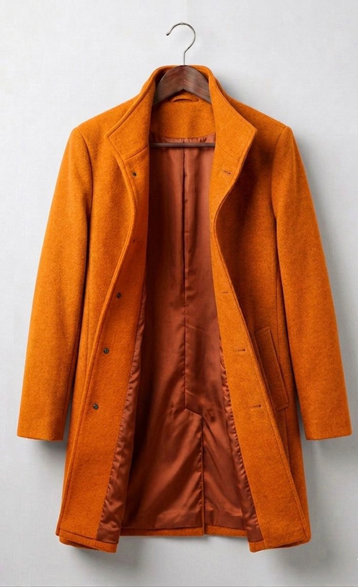 Orange long coat with notched lapels, button front, flap pockets, and lining.
