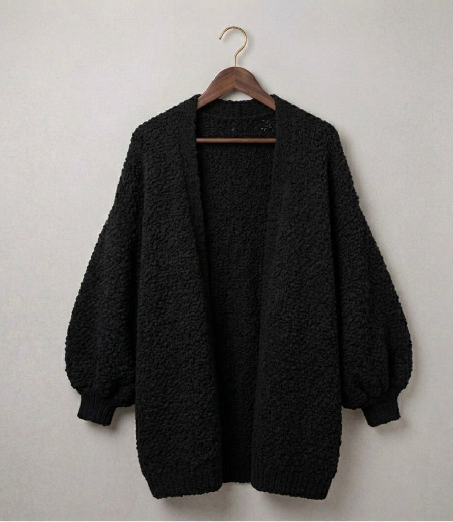 Black relaxed knit cardigan with open front and ribbed cuffs