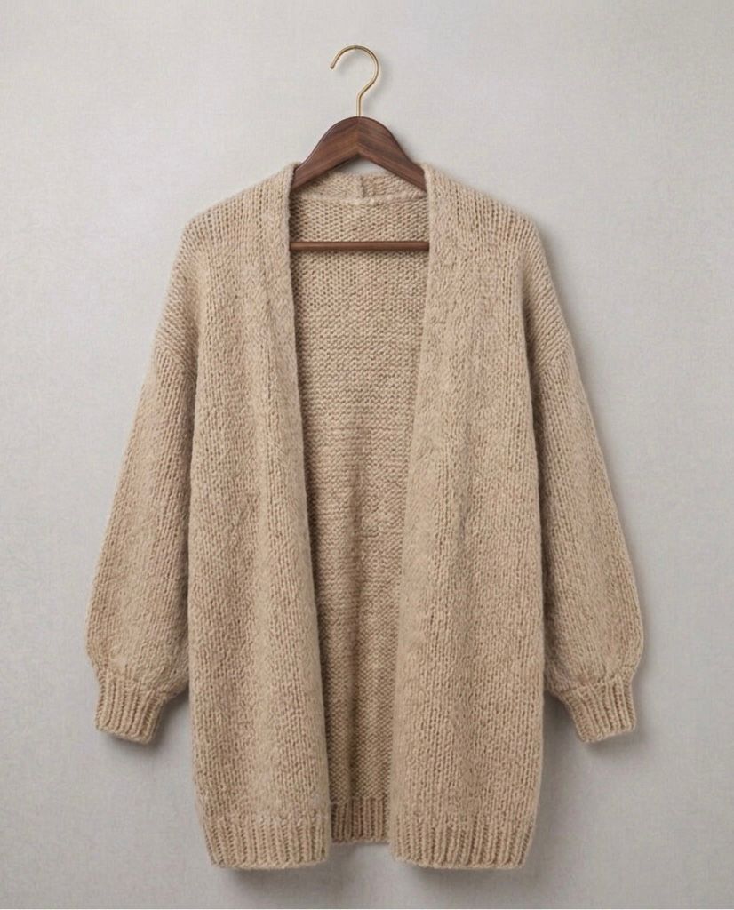 Beige relaxed knit cardigan with open front and ribbed hem