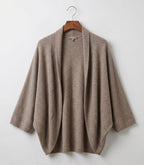 Taupe merino wool shawl hanging on a hanger, open front