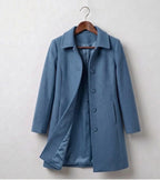 Blue double-breasted coat with notched lapels and button front, long sleeves, lined hem