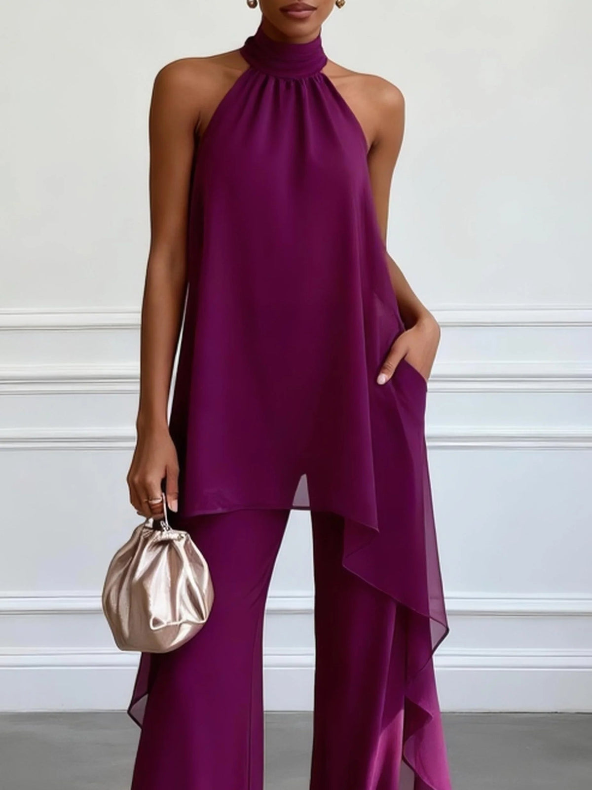 Purple halter sleeveless top with asymmetric drape hem and wide-leg pants