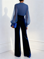 Blue velvet long-sleeve jumpsuit with V-neck and sheer mesh sleeves, back view