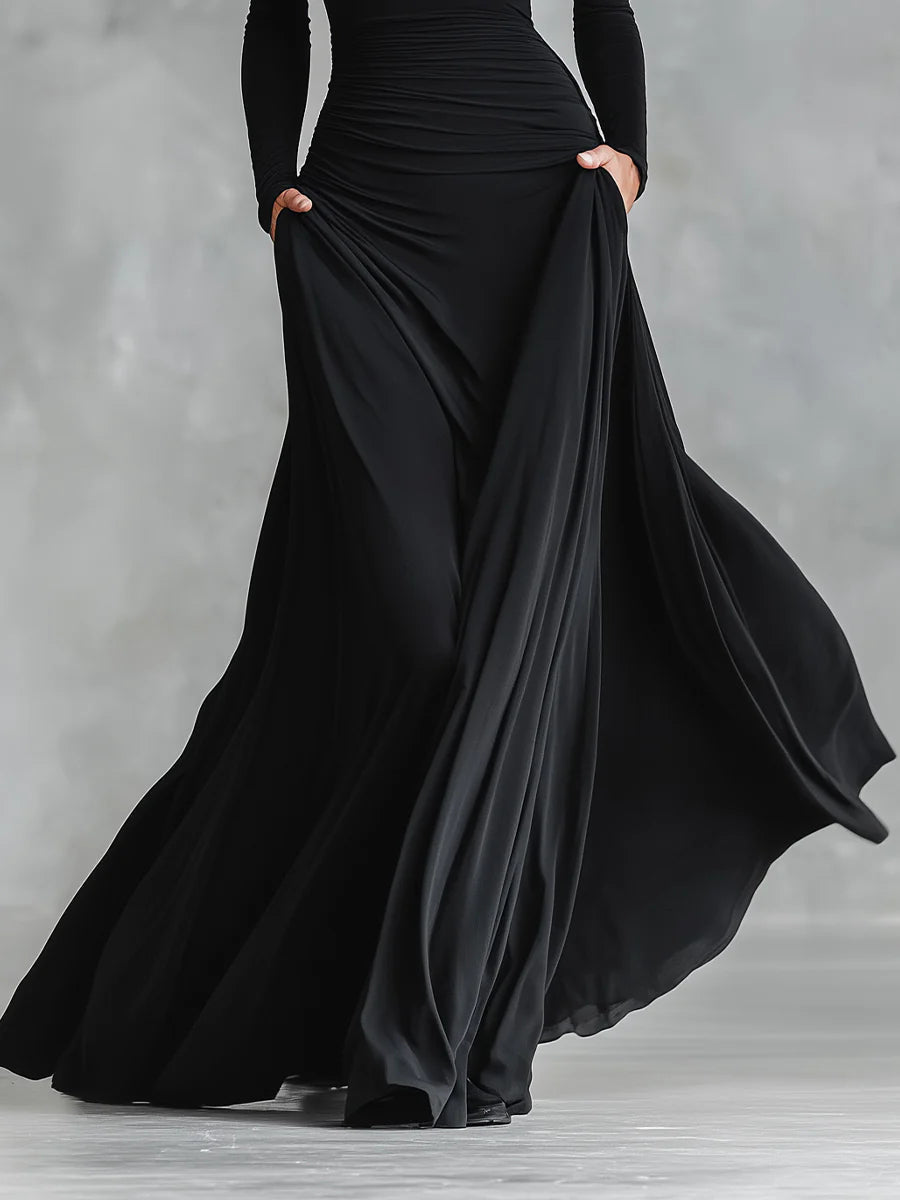 Black pleated maxi skirt with ruched waist detail and flowing draped panels