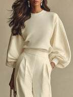 Ivory ribbed crewneck top with long dolman sleeves and high-waisted wide-leg pants