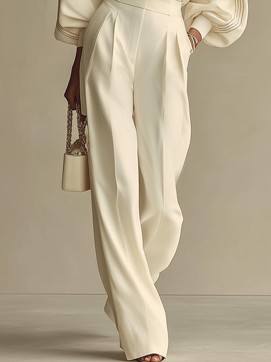 Ivory high-waisted wide-leg pants with pleated front, paired with crewneck top