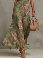 Floral chiffon halter maxi dress in green with pink blooms, flowing tiered-look skirt