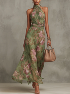 Floral chiffon halter maxi dress in green with pink blooms, gathered waist and flowing skirt