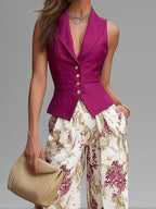 Sleeveless rose pink vest with gold buttons over floral wide-leg pants, side front