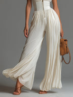 White pleated chiffon wide-leg jumpsuit with zip front and flowing drape