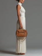 White sleeveless V-neck pleated wide-leg jumpsuit with zip front, side view