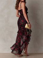 Black and red floral ruffle hem dress with ruched bodice and spaghetti straps, side view