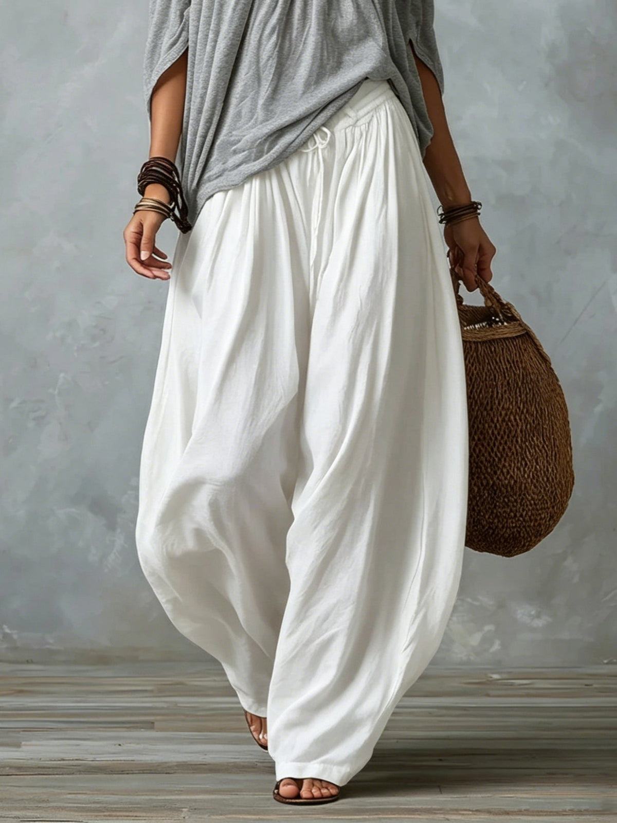 Grey off-shoulder top with white loose lantern pants and side drape