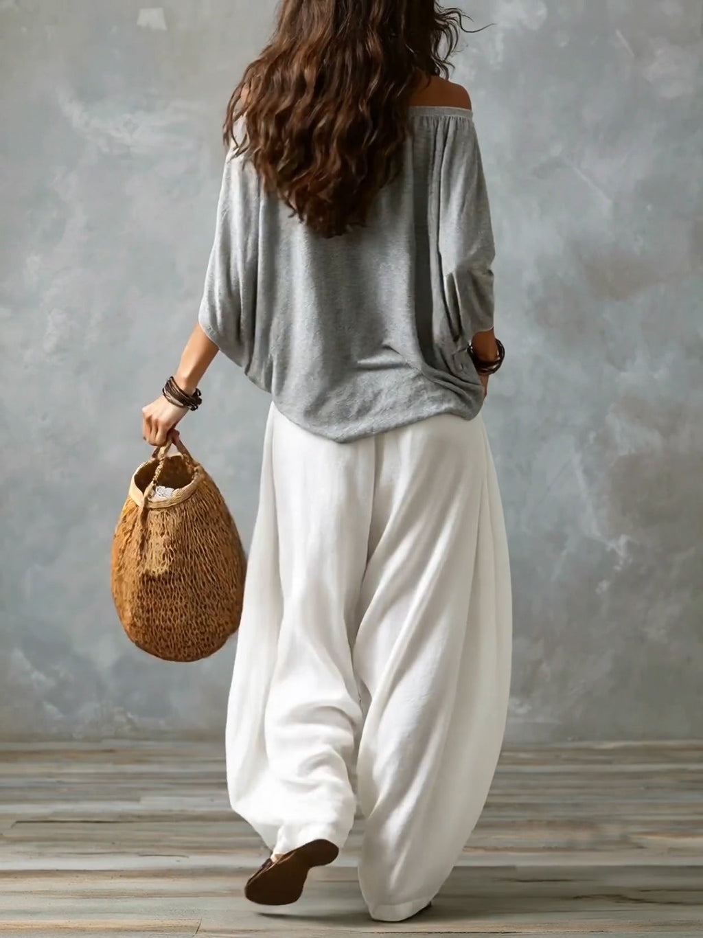 Grey off-shoulder top with white loose lantern pants, back view