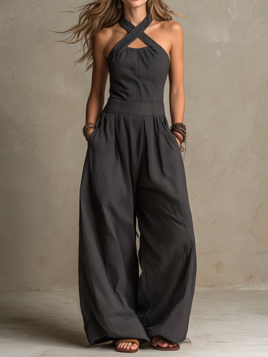 Charcoal halter jumpsuit with crisscross straps, pinstripe bodice, and wide legs