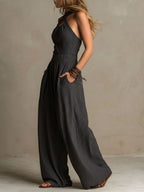 Charcoal sleeveless halter jumpsuit with open back tie and wide-leg pants