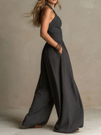 Charcoal halter wide-leg jumpsuit with cross-back straps and sleeveless bodice