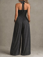 Charcoal backless halter jumpsuit with open back tie and wide-leg pant legs