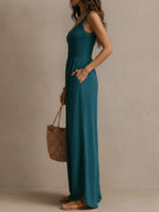 Blue-green sleeveless jumpsuit with scalloped lace V-neck and flowing wide legs