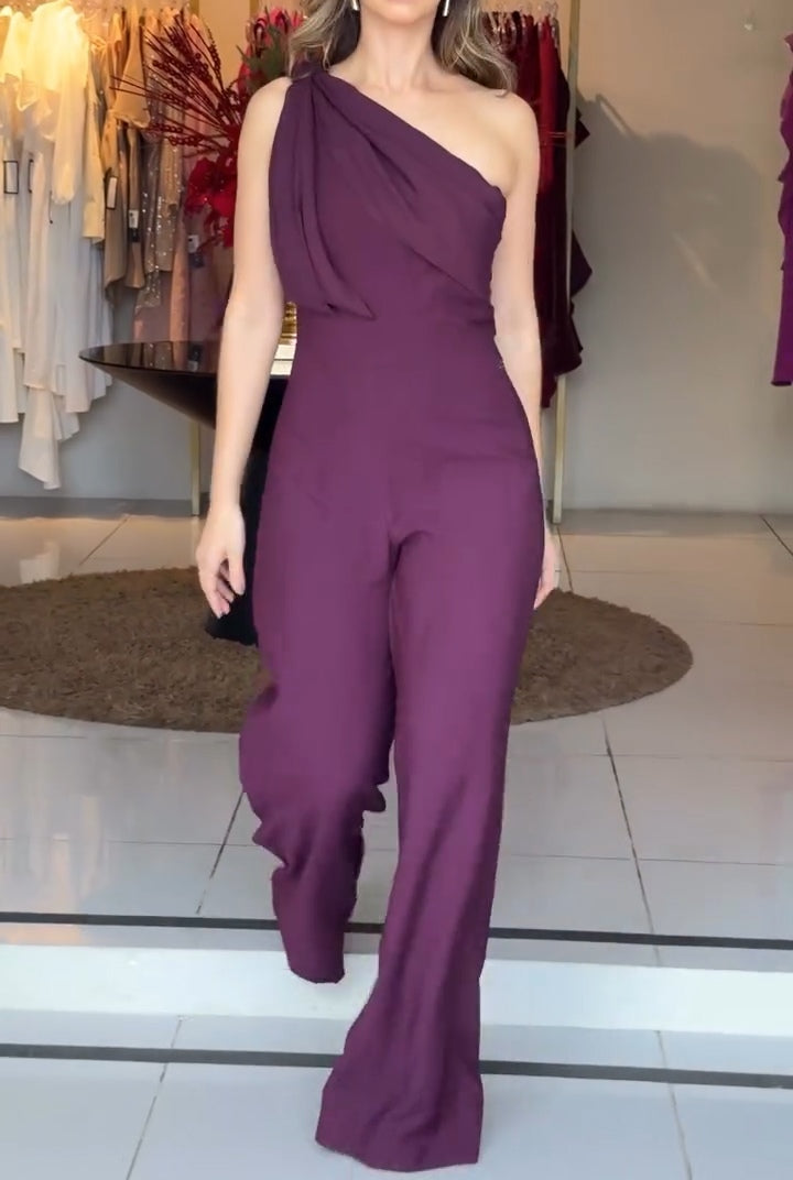 Purple one-shoulder jumpsuit with flowing draped shoulder and wide-leg silhouette