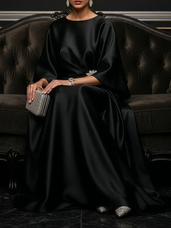 Black satin maxi dress, flowing fabric with bracelet-length drape and wide sleeves