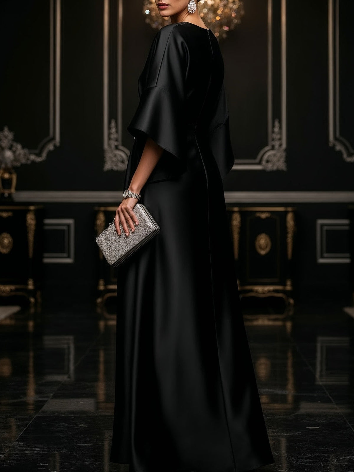 Black satin maxi dress with loose cape sleeves and side draped skirt