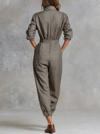 Gray-brown cotton-linen jumpsuit, back view with gathered waist and cuffed sleeves