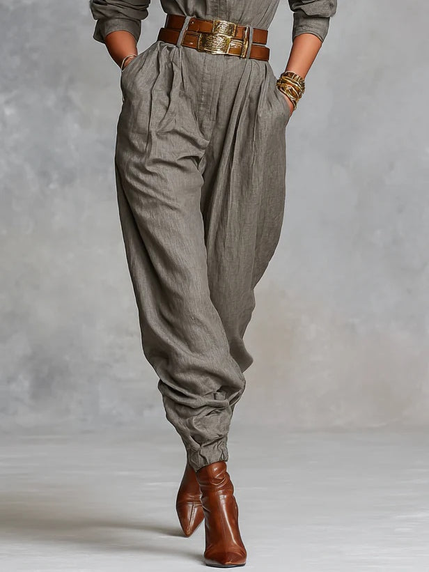 Gray-brown cotton-linen jumpsuit with elastic cuffs, gathered waist, and brown belt