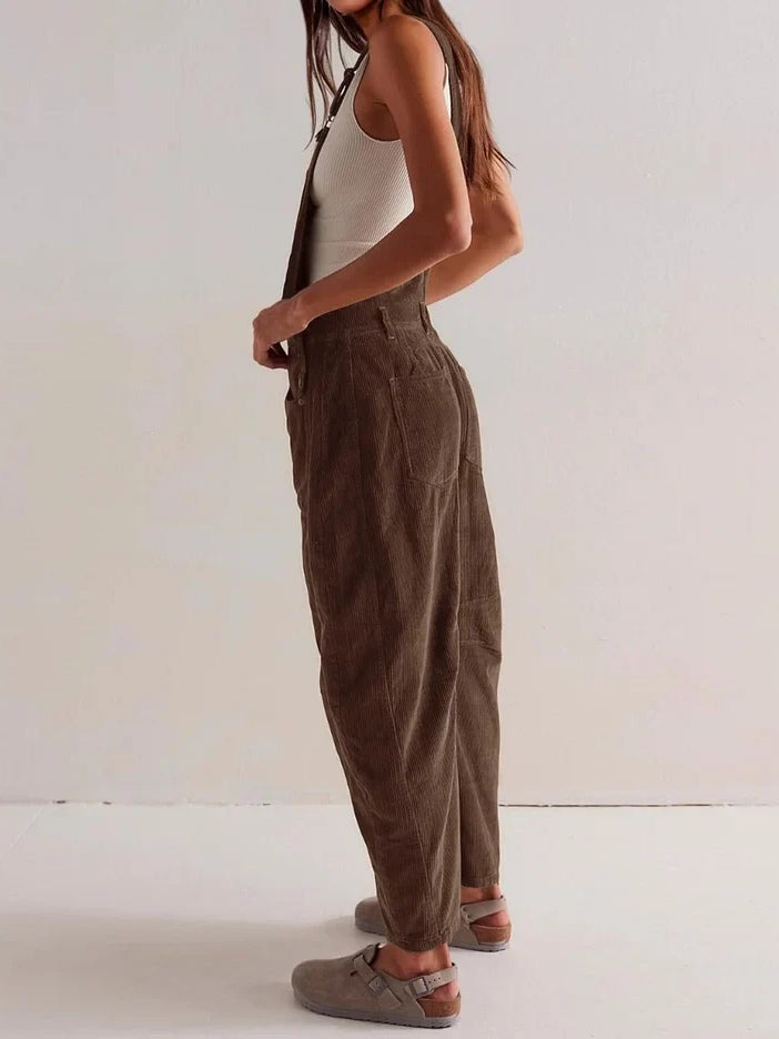 Brown corduroy workwear jumpsuit with front bib and tapered wide-leg fit