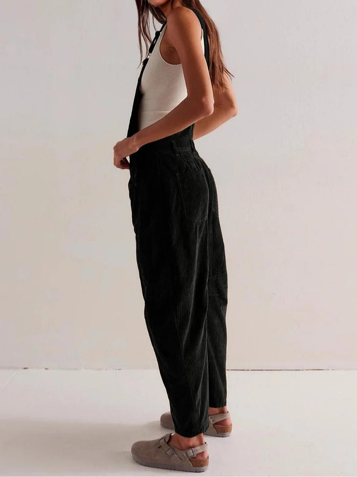 Black corduroy workwear jumpsuit with front bib and wide-leg fit