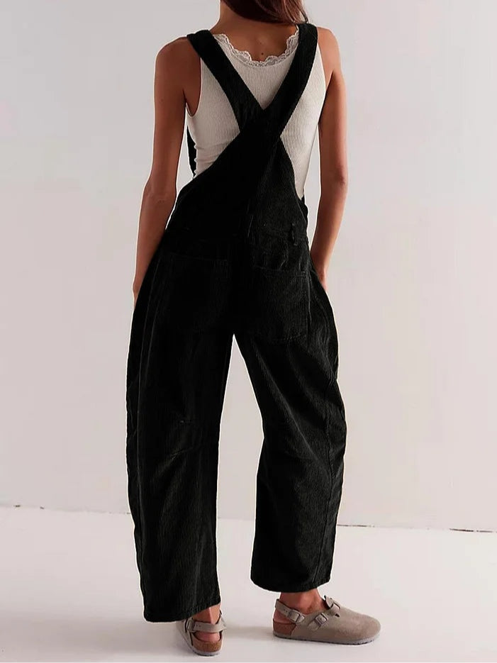 Black corduroy sleeveless jumpsuit with cross-back straps and wide legs