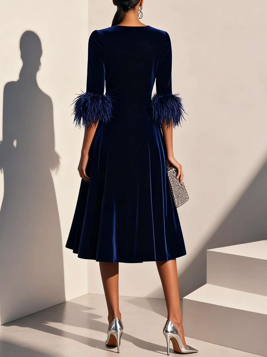 Dark blue velvet midi A-line dress, back view with feather-trimmed sleeves