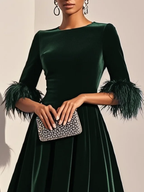 Green velvet midi A-line dress with round neck, short sleeves, and feather cuffs