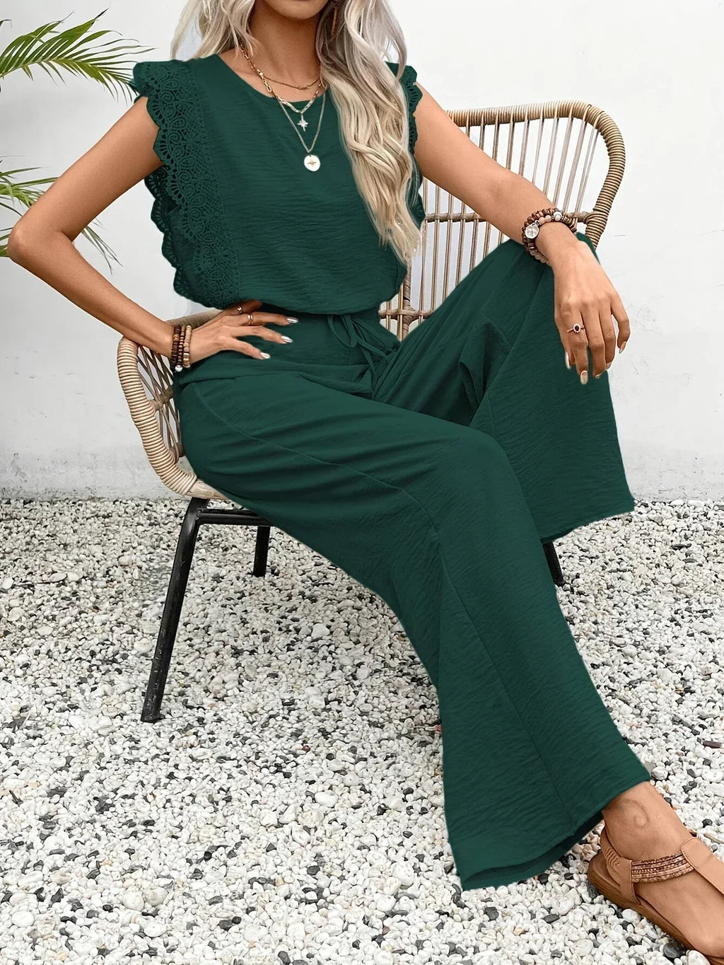 Dark green two-piece set with ruffled sleeveless top and wide-leg pants