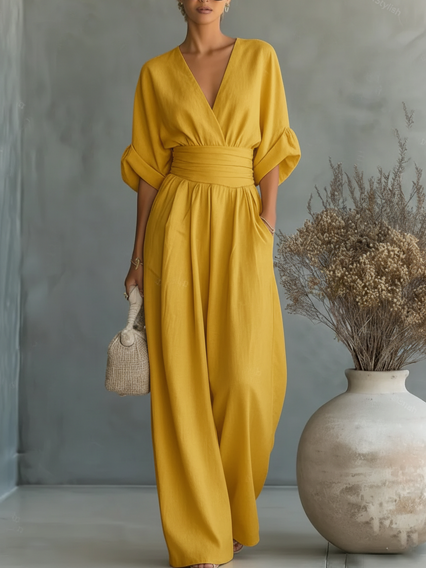 Yellow V-neck high-waist jumpsuit with cinched waist and wide-leg flow, dolman sleeves