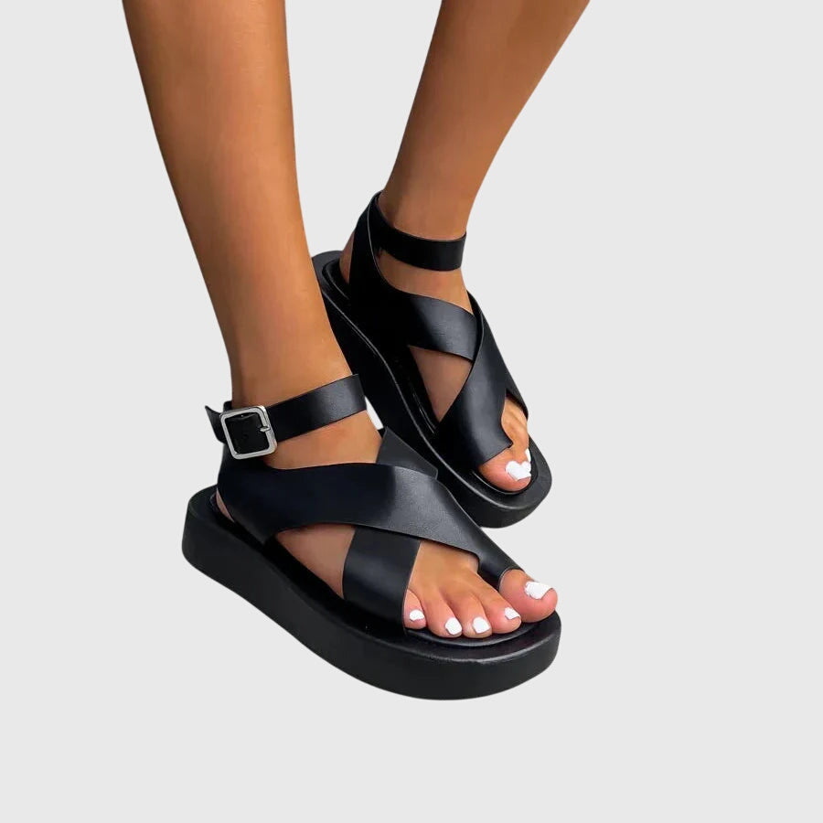 Black orthopedic sandals with two straps and adjustable buckle at ankle